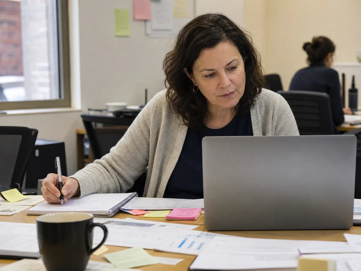An everyday professional using Claude alongside notes and work documents